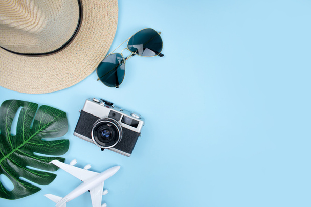 Top view of tourist accessories with film cameras, hats, sunglas - 写真・画像