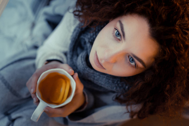 Close up of cute girl that holding cup with tea - Фото, зображення
