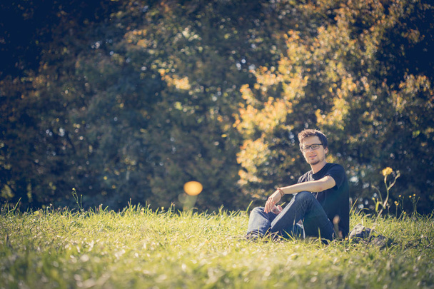 Man relaxing on green grass outdoors - Foto, immagini