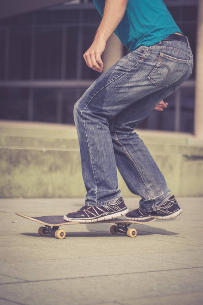 man in  sneakers with a skateboard  - Foto, afbeelding