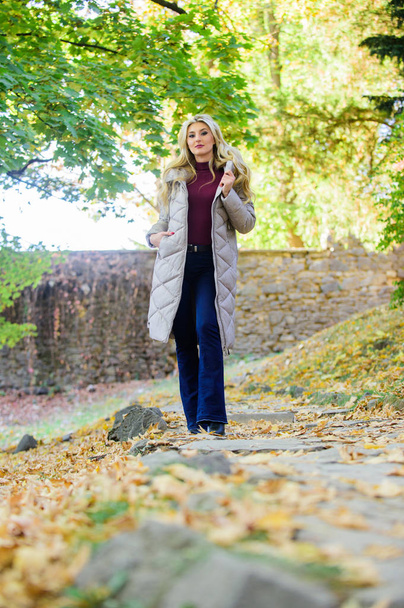 Puffer jacket casual and comfortable style. Woman wear warm grey jacket. Jacket everyone should have. Puffer fashion trend concept. Girl fashionable blonde walk in autumn park. Oversized jacket trend - Foto, Imagen