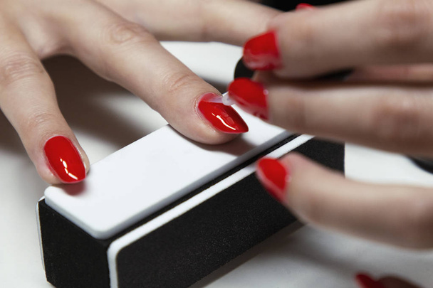 applying red gel nail polish on women's nails - Photo, Image