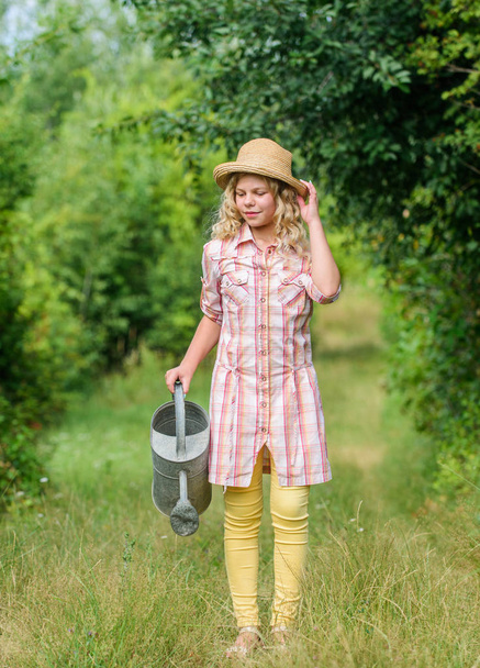 perfect day. little girl farmer care plants. farming and agriculture. spring country side village. summer season. small girl with watering can. earth day. environment ecology. nature protection - Fotó, kép