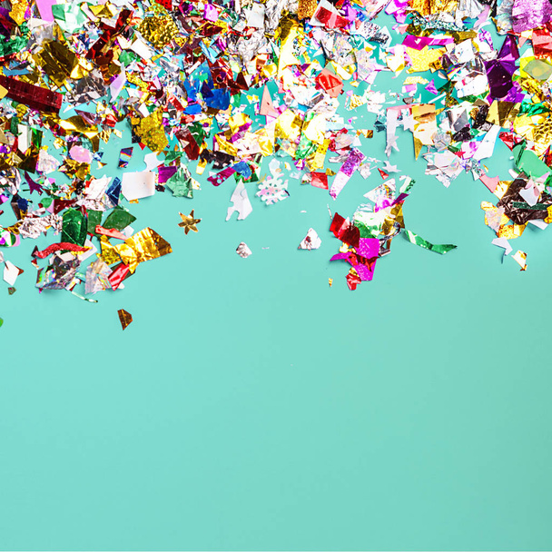 Party confetti on neo mint color background. - Photo, Image