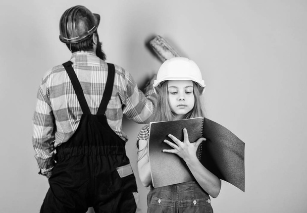 Child renovation room. Family remodeling house. Little fathers helper. Father bearded man and daughter hard hat helmet uniform renovating home. Home improvement activity. Kid girl planning renovation - Foto, Bild