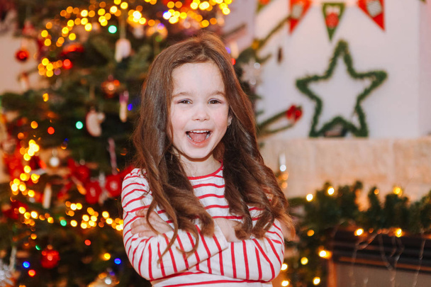 Happy little kids under christmas tree at home. - Photo, Image