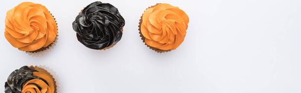 flat lay with delicious Halloween cupcakes on white background with copy space, panoramic shot - Φωτογραφία, εικόνα