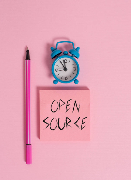 Text sign showing Open Source. Conceptual photo denoting software which original source code freely available Metal vintage alarm clock wakeup blank notepad marker colored background. - Photo, Image