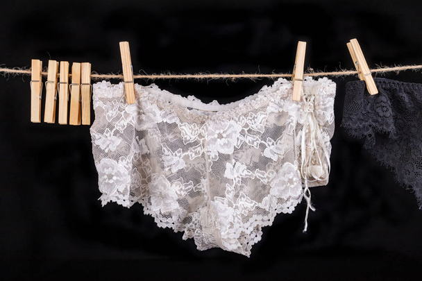 Linen drying on a string. Sexy women's panties pinned to a strin - Photo, Image