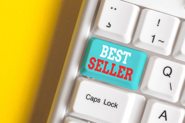 Writing note showing Best Seller. Business photo showcasing book or other product that sells in very large numbers White pc keyboard with note paper above the white background. - Photo, Image