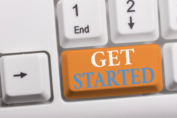 Writing note showing Get Started. Business photo showcasing asking someone to begin task endeavour or process right now White pc keyboard with note paper above the white background. - Photo, Image