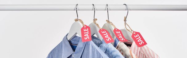 elegant shirts hanging with sale labels isolated on white, panoramic shot - Φωτογραφία, εικόνα