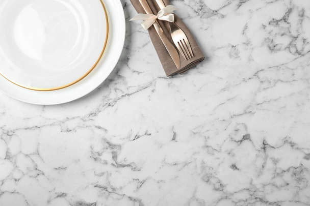 Beautiful table setting on white marble background, flat lay. Space for text - Photo, image