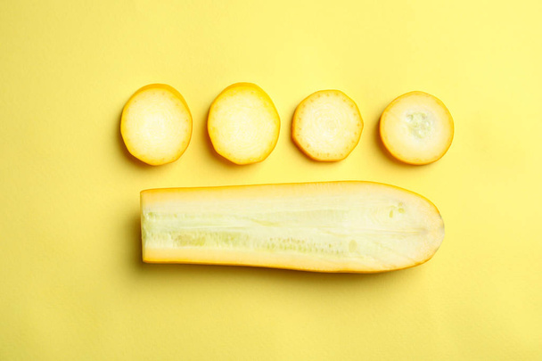 Fresh ripe cut zucchini on yellow background, flat lay - Zdjęcie, obraz