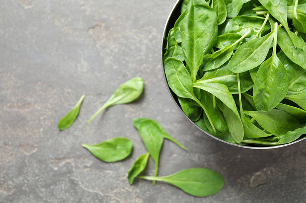 Fresh green healthy spinach on grey table, top view. Space for text - Фото, зображення