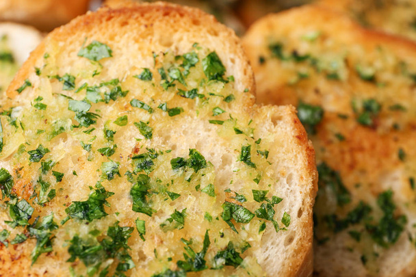 Slices of toasted bread with garlic and herbs as background, closeup - Φωτογραφία, εικόνα