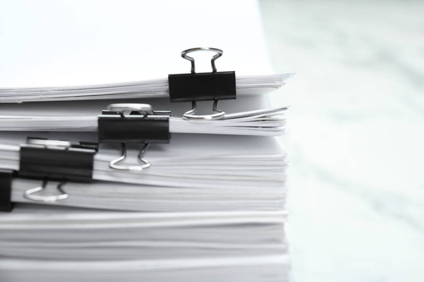 Stack of documents with binder clips on marble table, closeup - Фото, зображення