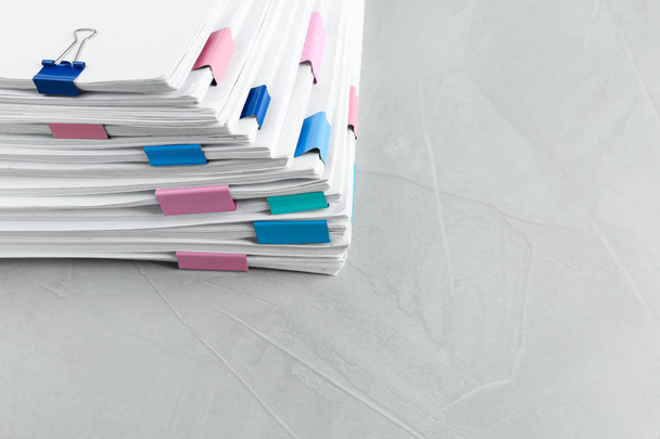 Stack of documents with binder clips on light table - Foto, Bild