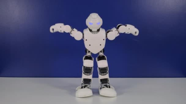 Toy robot is moving hands on table - Footage, Video