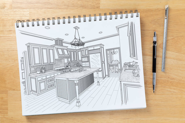 Szkic pad na biurku z rysunkiem niestandardowe wnętrze kuchni obok inżynierii ołówek i skala linijki. - Zdjęcie, obraz