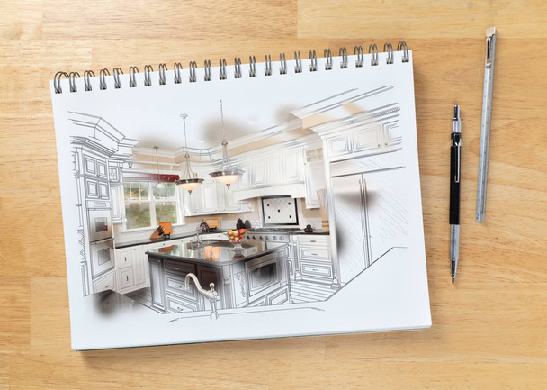 Sketch Pad na mesa com desenho de cozinha personalizada e pincelada mostrando construção acabada ao lado de lápis de engenharia e escala de régua
. - Foto, Imagem