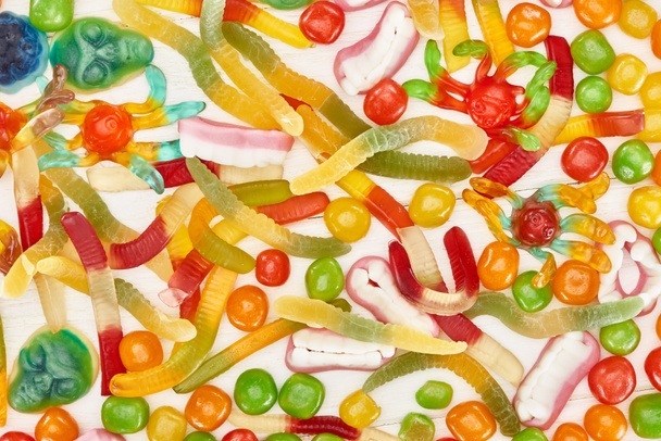 top view of delicious colorful gummy spooky Halloween sweets - Фото, изображение