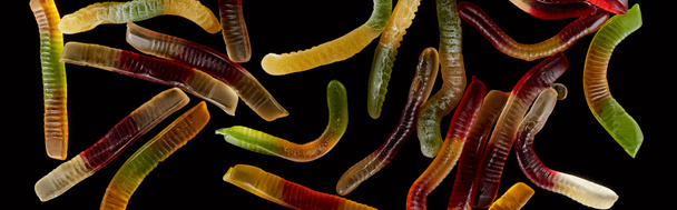 top view of colorful gummy worms isolated on black, Halloween treat - Photo, Image