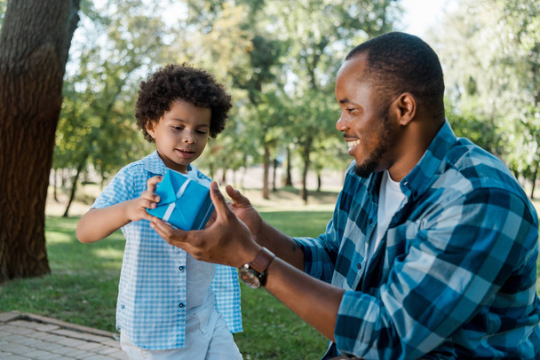 happy of african american father and son holding blue gift box  - Photo, Image