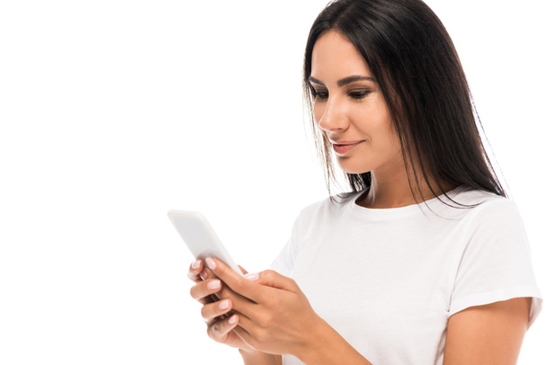 happy woman in white t-shirt using smartphone isolated on white  - Foto, afbeelding