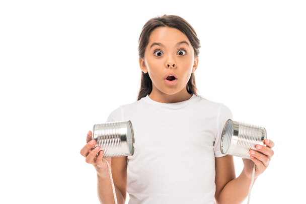 shocked kid holding tin cans isolated on white  - Foto, afbeelding