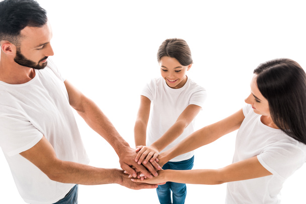overhead view of positive family putting hands together isolated on white   - Φωτογραφία, εικόνα