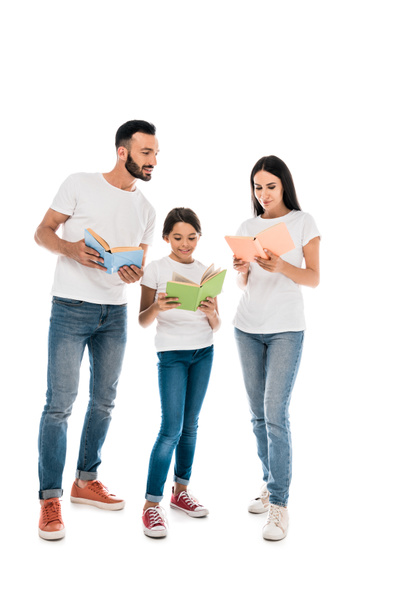 happy parents and kid standing and holding books isolated on white  - Foto, afbeelding