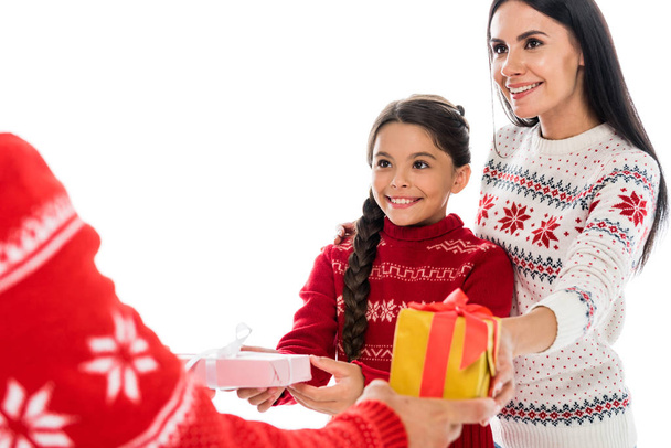 cropped view of man giving presents to wife and daughter isolated on white  - Photo, image