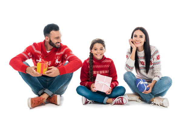 happy family in sweaters holding gifts on white  - Valokuva, kuva