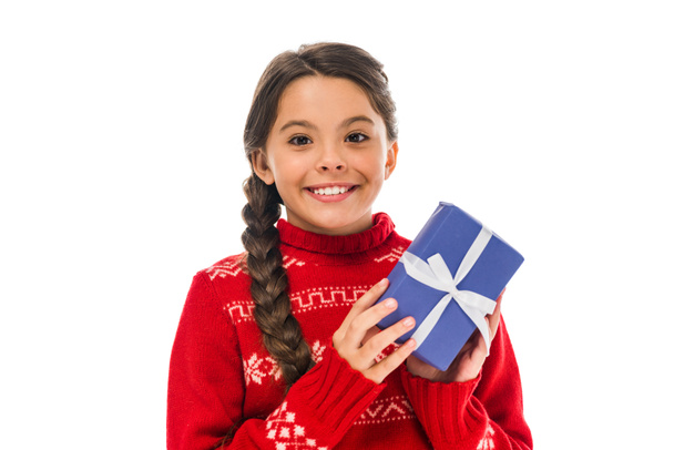 happy kid in sweater holding present isolated on white  - Fotó, kép