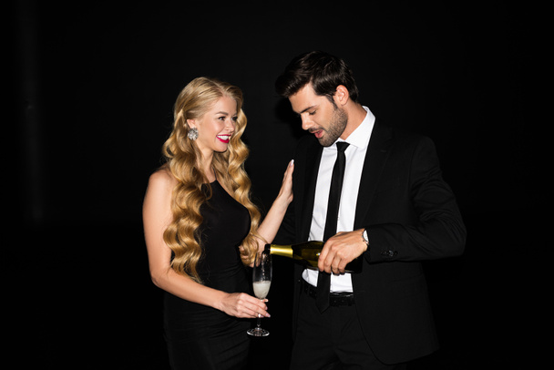 beautiful couple celebrating with champagne isolated on black - Fotoğraf, Görsel