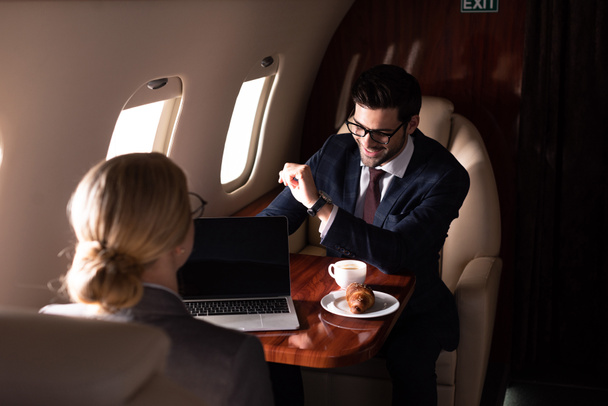 executive businesspeople working together with laptop in airplane  - Фото, зображення