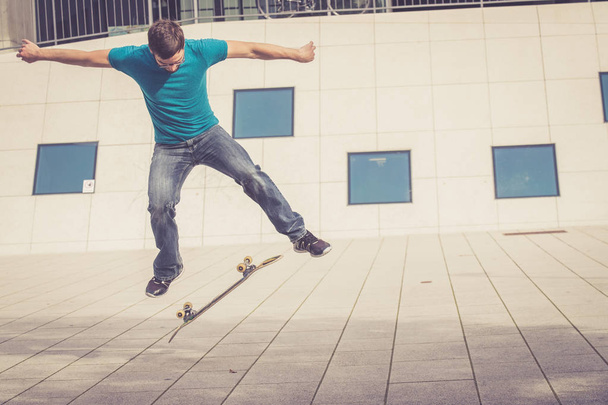 male skateboarder doing jump trick - Zdjęcie, obraz