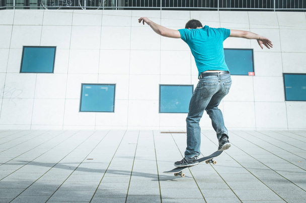 male skateboarder doing jump trick - 写真・画像