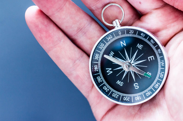 Vintage compass in mans hand, adventure and discovery concept   - Valokuva, kuva