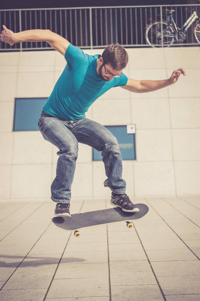 male skateboarder doing jump trick - Фото, изображение