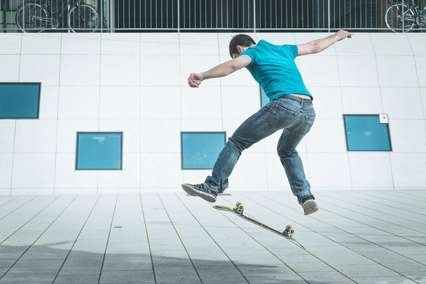 male skateboarder doing jump trick - Fotoğraf, Görsel