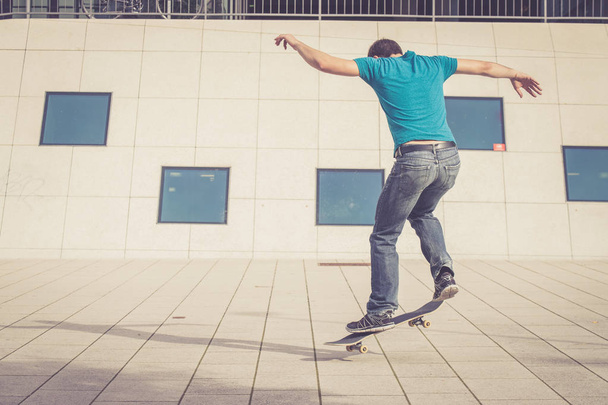 male skateboarder doing jump trick - Fotografie, Obrázek
