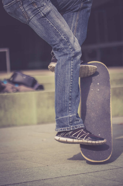 man in  sneakers with a skateboard  - Fotó, kép
