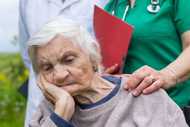 Portrait of elderly woman with dementia disease - Photo, Image