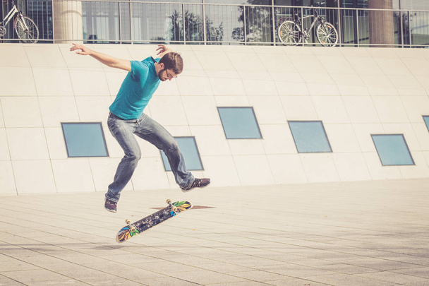 male skateboarder doing jump trick - Valokuva, kuva