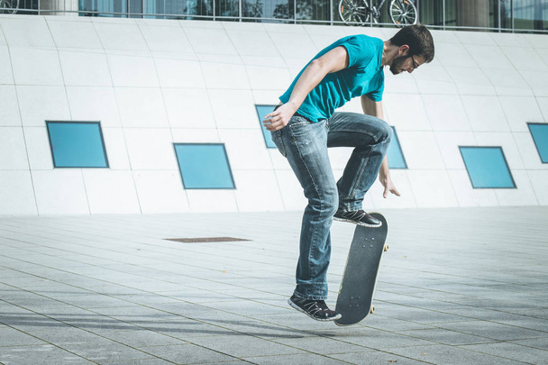 male skateboarder doing jump trick - Fotó, kép