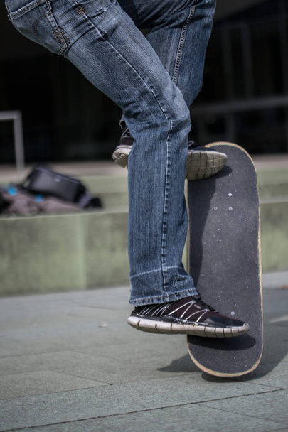 man in  sneakers with a skateboard  - Zdjęcie, obraz
