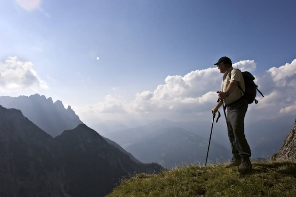 Senior hiker enjoying amazing landscape of the Alps - 写真・画像