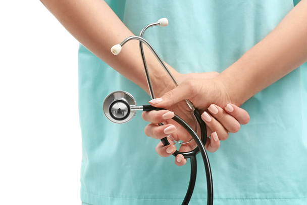 Female nurse with stethoscope on white background, closeup - Фото, зображення